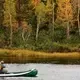 Vue d'un pêcheur au bord d'un lac canadien à l'automne