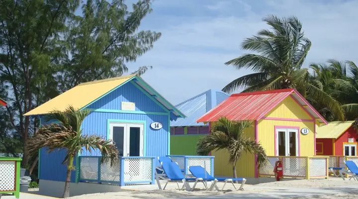 Cabanes colorées sur une plage des Bahamas Billets d'avion pas chers pour les Bahamas